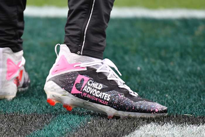 San Francisco 49ers quarterback Brock Purdy's black and pink cleats.